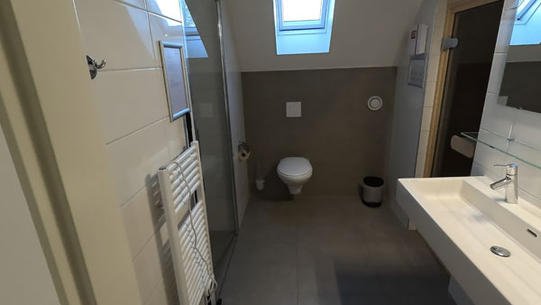 Bathroom with shower with sun shower, sauna and toilet