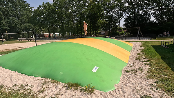 Girl on the air trampoline in the playground at Landal Puur Exloo