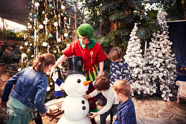 Orry with a family at a snowman and Christmas tree