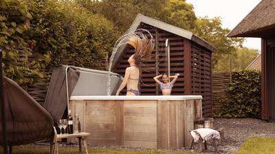 Children play in the whirlpool at a holiday villa at the Dutchen Park Duynvoet holiday park