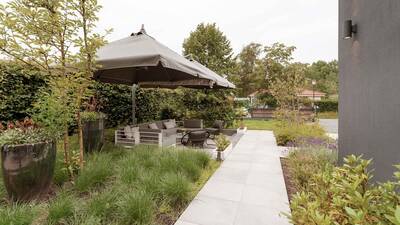 Lounge set in the garden of a holiday home at Dutchen Villapark Suitelodges Gooilanden