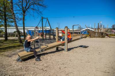Children on a seesaw in a playground at the EuroParcs Zuiderzee holiday park