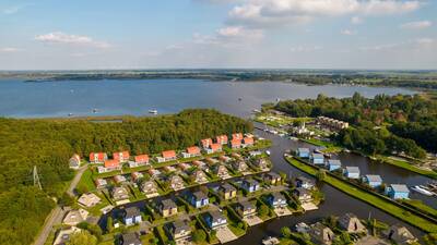 Aerial photo of holiday park Landal De Bloemert with holiday homes and lots of water
