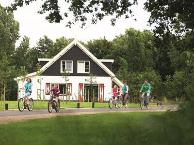 A family on a bicycle for a holiday home at the Landal Resort Haamstede holiday park