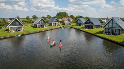 Aerial view of people in canoes and holiday homes at Landal Waterpark De Alde Feanen