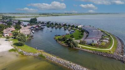 Aerial view of holiday homes at Makkumbeach Beach Resort Makkum and the IJsselmeer