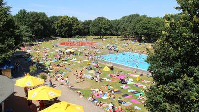 Aerial view of the outdoor pool with sunbathing area of holiday park Molecaten Bosbad Hoeven