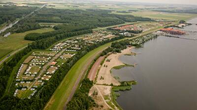 Aerial view of holiday park Molecaten Park Flevostrand right on Lake Veluwe