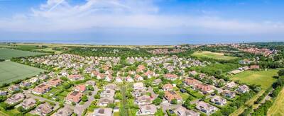 Aerial photo of the Roompot Buitenhof Domburg holiday park with the sea on the horizon