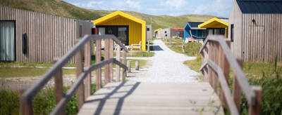 Bridge with holiday homes behind it at the Roompot Callantsoog holiday park