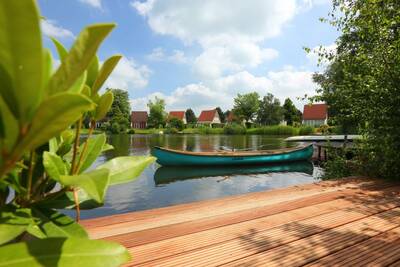 View from a deck on the water at a holiday home at Roompot Holiday Park Emslandermeer