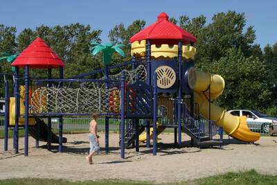 Child plays in the playground at Roompot Holiday Park Callassande