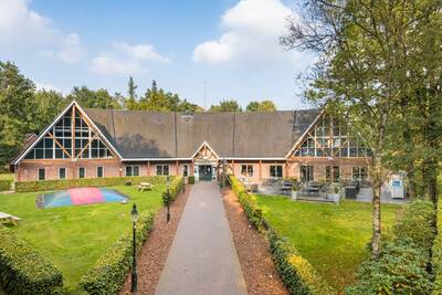 The main building and playground of the Roompot Landgoed Het Grote Zand holiday park