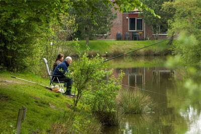 A man and woman fishing at Roompot Vakantiepark Weerterbergen