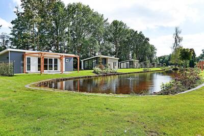 Holiday homes around a pond at Holiday Park De Lochemse Berg