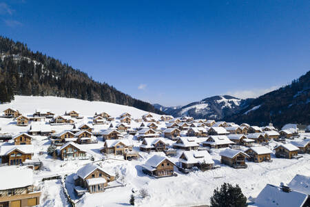 Aerial view of detached holiday homes in the snow at Alps Resorts Almdorf Hohentauern