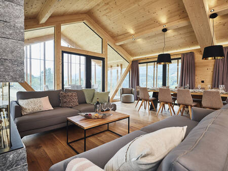 Spacious living room with fireplace of a chalet at Alps Resorts Bergresort Hauser Kaibling