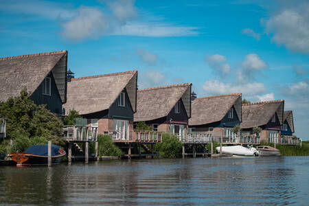 Detached villas with a thatched roof at the Beach Resort Makkum holiday park