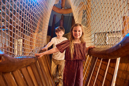 Children on a rope bridge in the indoor playground (Kodidi Ground) of Safari Resort Beekse Bergen