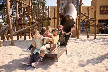 A family on a slide in a playground at Safari Resort Beekse Bergen
