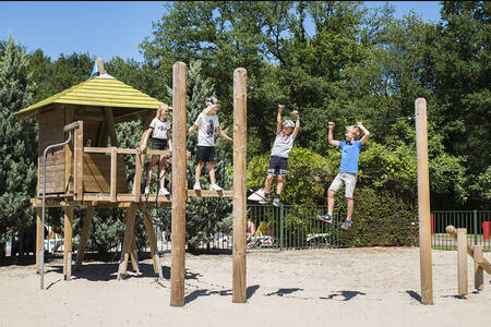 Children playing in a playground at Camping Vreehorst in the Achterhoek near Winterswijk