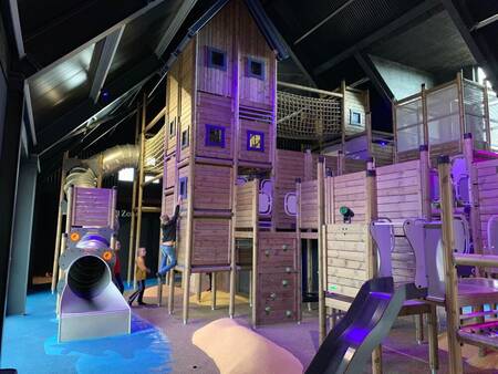 Children playing in the large indoor playground at Camping Zonneweelde holiday park