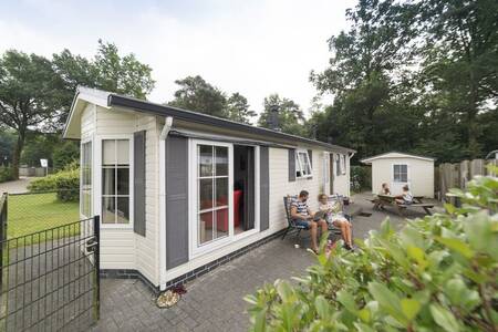 People in the garden of a chalet at the Camping de Noetselerberg holiday park