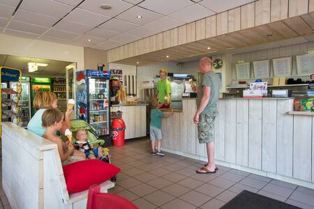 People buy ice creams in the snack bar of the Camping de Noetselerberg holiday park