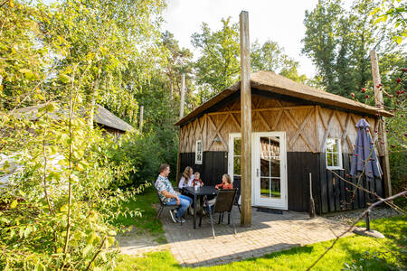 People in the garden of a holiday home at the Camping de Norgerberg holiday park