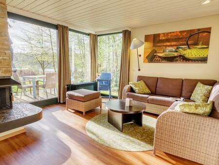 Living room with fireplace of a holiday home at Center Parcs Bispinger Heide
