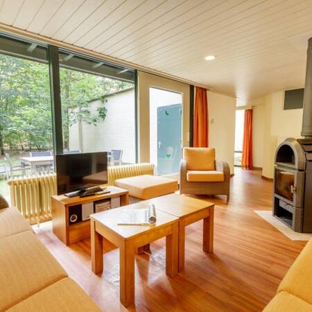 Living room with wood stove of a holiday home at Center Parcs Het Meerdal