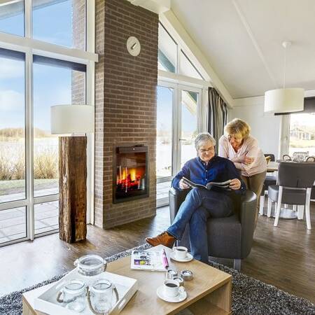 Enjoy the warmth of the fireplace in your holiday home at Center Parcs Parc Sandur