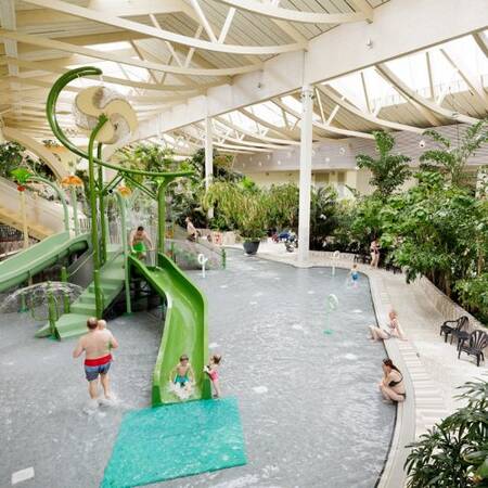 Smaller green slide in the Water Playhouse in the Aqua Mundo at Center Parcs Park Bostalsee