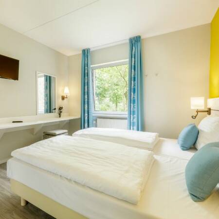 Bedroom with luxury box spring beds in Center Parcs Park Nordseeküste
