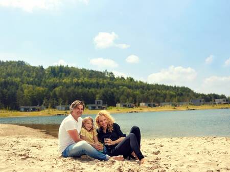 Relaxing on the beach by the lake at Center Parcs Terhills Resort