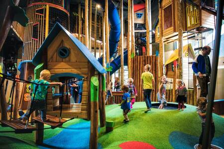 Children play in the indoor playground "Tippedoki" of camping site De Berenkuil