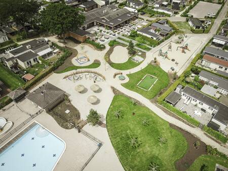 Aerial view of the outdoor pool, playground and restaurant of holiday park De Boshoek