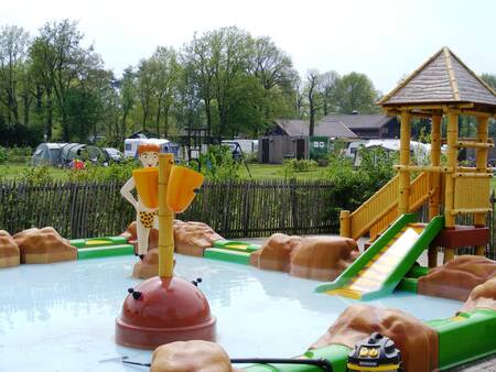 The paddling pool with outdoor play equipment at holiday park De Boshoek