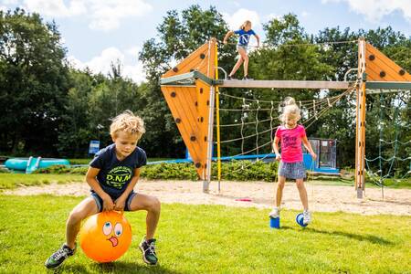 Children playing in a playground at camping De Witte Berg