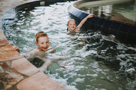 Children swim in the rapids of the indoor pool at the Dierenbos holiday park