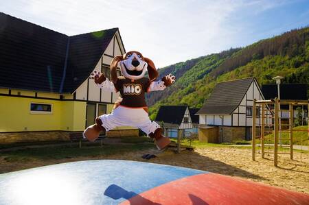 Mascot Mio jumps on an air trampoline in a playground at the Dormio Eifeler Tor holiday park