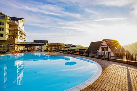 The outdoor pool with sun loungers at the Dormio Eifeler Tor holiday park