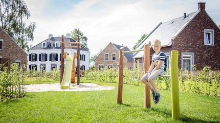 Child in a playground in the Kidskwartier near Kidswoningen at holiday park Dormio Resort Maastricht