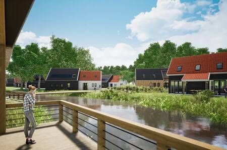 Woman stands on the terrace above the water of a holiday home at the Dormio Resort Nieuwvliet-Bad