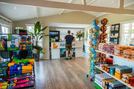 Man is standing at the reception of holiday park EuroParcs Aan de Maas