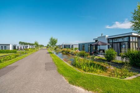 Holiday homes on a ditch and avenue at the EuroParcs Bad MeerSee holiday park