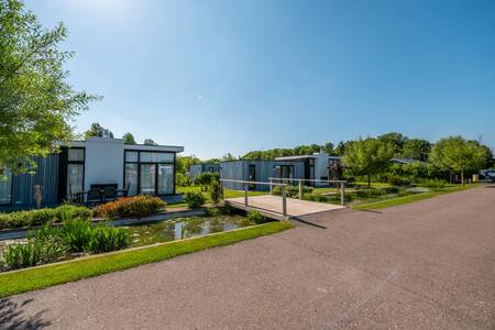 Holiday homes on a ditch with a bridge at the EuroParcs Bad MeerSee holiday park