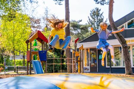 Children jump on the air trampoline in a playground at the EuroParcs Beekbergen holiday park