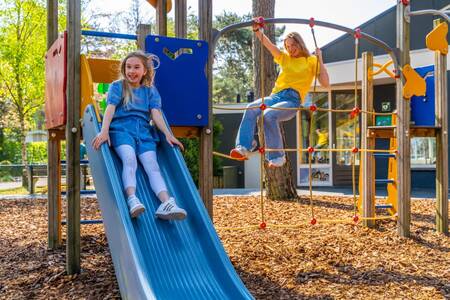 Children play in the playground at the EuroParcs Beekbergen holiday park