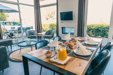 Set table in a living room of a holiday home at holiday park EuroParcs De Biesbosch